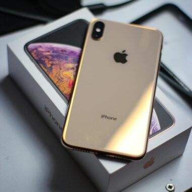 Close-up of a modern smartphone placed on its box, highlighting elegant design and tech innovation.